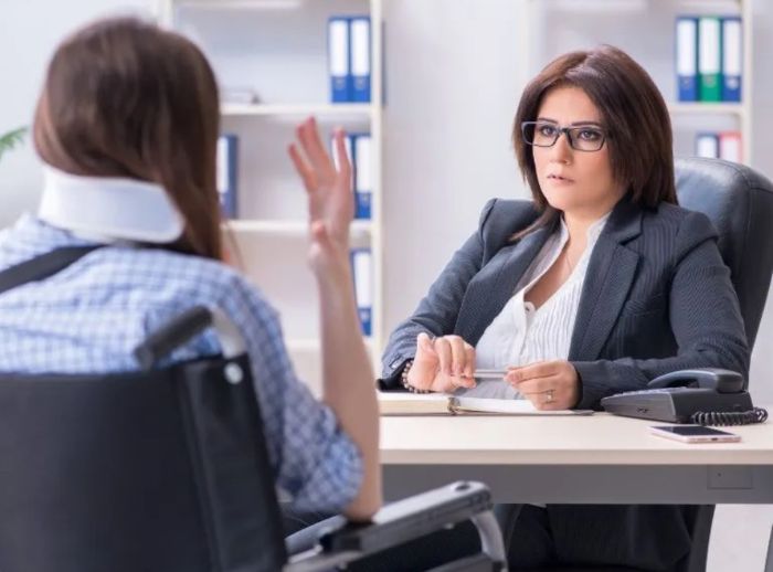 Injured woman talking to a car accident lawyer.