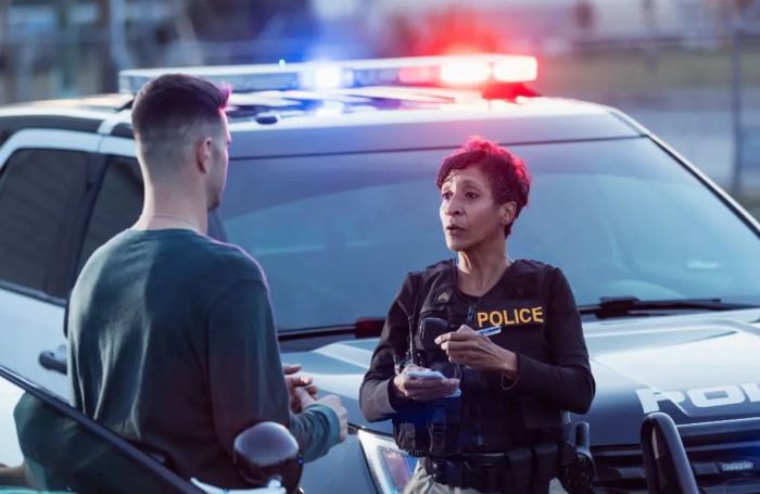 Driver talking to the police after car accident.